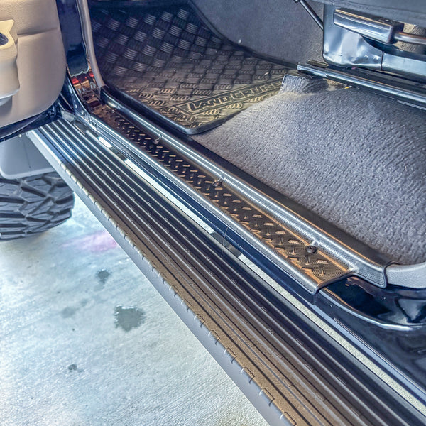 Stainless steel door sill trim fitted to LandCruiser rear door with LAND CRUISER branded floor mat