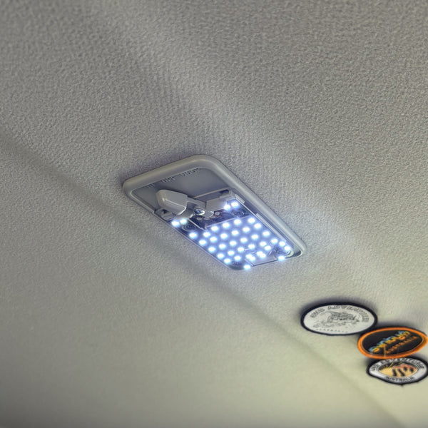 Interior LED light fitted to LandCruiser roof, LED array lit, ON/OFF/DOOR switch visible